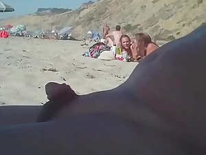 Man with a small penis on the top of the nudist beach