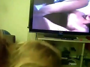 Mommy gives son head while he watches porn